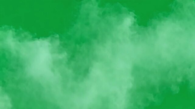 White smoke is slowly forming and moving on a solid green screen background. Perfect for compositing, visual effects, and creative projects
