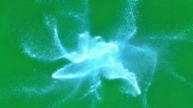 Blue particles are colliding and dispersing on a green screen background. This animation is perfect for projects that require a sense of energy and movement