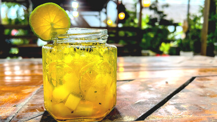 Fresh drink garnished with lemon on the cafe table