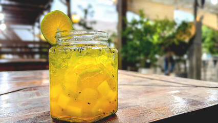 Fresh drink garnished with lemon on the cafe table