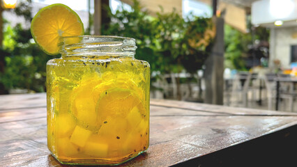 Fresh drink garnished with lemon on the cafe table