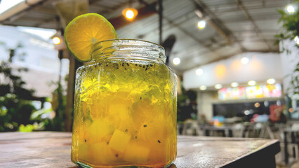 Fresh drink garnished with lemon on the cafe table