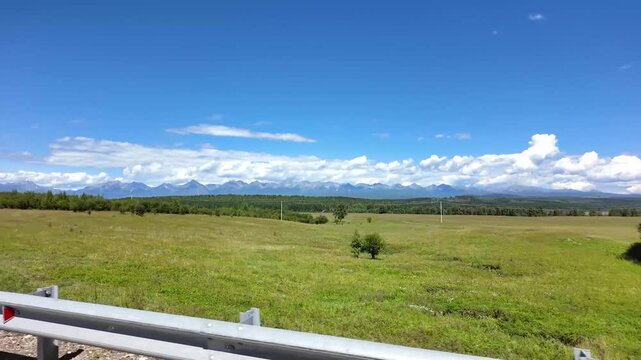 View from the side window of the car to the Tunka mountains. Auto tour of the Tunka Valley, Buryatia