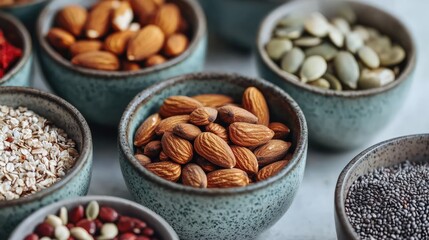 A collection of various nuts and seeds displayed in decorative bowls, showcasing their rich textures and colors.