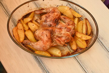 baked potatoes with roasted chicken photo from above, cinnamon crispy crust of roasted chicken and potatoes, baked dinner 