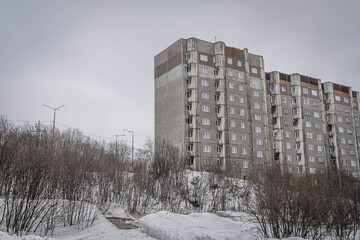 The socialism-era panel building on the snowy hill at Murmansk, Russian north.
