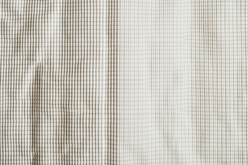 A seersucker texture background features a puckered, striped surface with alternating smooth and wrinkled sections