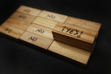 Concept Wooden blocks scattered on a dark surface, most say 