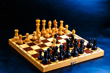 Wooden chess pieces on the chessboard. Intellectual game -chess. Chess pieces on the Board. A game of chess.