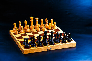 Wooden chess pieces on the chessboard. Intellectual game -chess. Chess pieces on the Board. A game of chess.