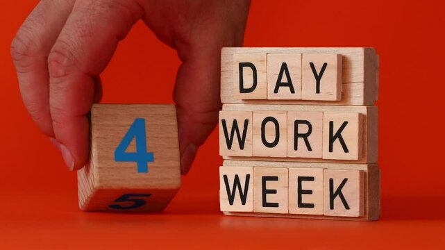 4 day work week symbol. Concept words. Businessman turns the cube and changes words '5 day work week' to '4 day work week'.. Beautiful orange background. Business concept. Copy space