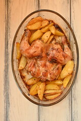 baked potatoes with roasted chicken photo from above, cinnamon crispy crust of roasted chicken and potatoes, baked dinner 