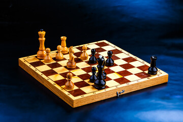 Wooden chess pieces on the chessboard. Intellectual game -chess. Chess pieces on the Board. A game of chess.