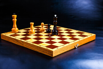 Wooden chess pieces on the chessboard. Intellectual game -chess. Chess pieces on the Board. A game of chess.