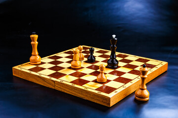 Wooden chess pieces on the chessboard. Intellectual game -chess. Chess pieces on the Board. A game of chess.
