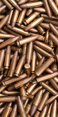 Ammunition background with metallic bullets in a pile for military and shooting themes