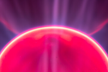 Abstract background with red electric plasma sphere from plasma lamp. Close up view....