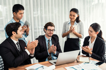 Diverse of business people from various ethnic group working in modern office environment. Productive and multi ethnic office workers engage in discussion for strategic business marketing. Meticulous