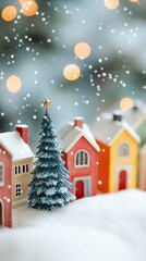 Fototapeta premium Miniature winter wonderland scene with colorful toy houses and a decorated Christmas tree, surrounded by falling snow and magical bokeh lights.