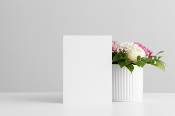 Wedding table number card mockup with a floral arrangement.