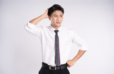 Portrait of young Asian business man posing on white background