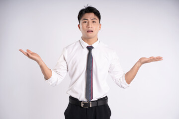 Portrait of young Asian business man posing on white background