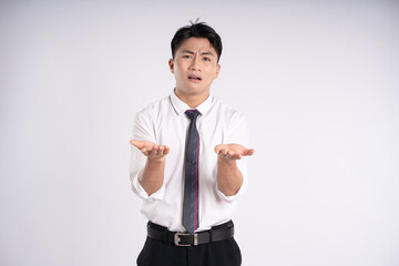 Portrait of young Asian business man posing on white background
