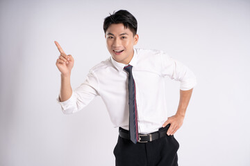 Portrait of young Asian business man posing on white background