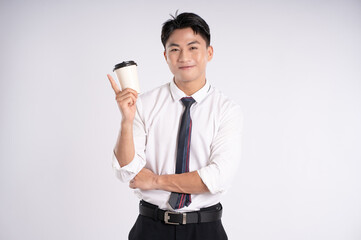 Portrait of young Asian business man drinking coffee and posing on white background