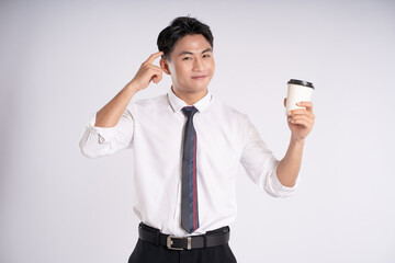 Portrait of young Asian business man drinking coffee and posing on white background