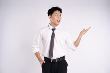 Portrait of young Asian business man posing on white background
