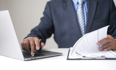 Executive CEO businessman checking job applicant documents resumes, interviews, and signing to approve the contract in the office room