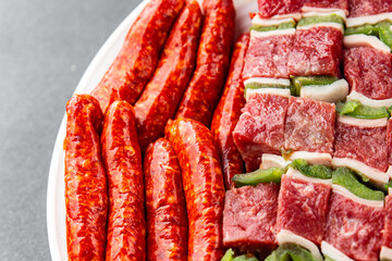 meat sausage assorted juicy pork, beef fresh gourmet food background on the table rustick food top...