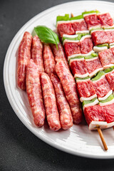 meat sausage assorted juicy pork, beef fresh gourmet food background on the table rustick food top view copy space