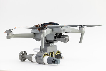 Army drone with mechanism for dropping grenades on white isolated background. Concept military UAVs using in weapon, Engineering development for war