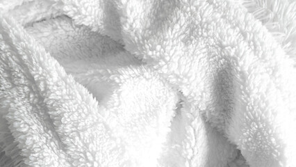 Clean white bedsheets and folded blanket on solid background, home decor concept