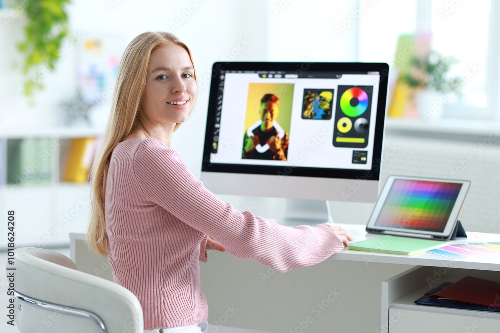 Poster graphic designer working with computer at table in office