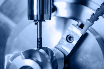 Modern CNC milling machine during operation, blue toning. Produced cutting metal parts, industry heavy factory