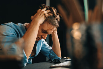 Thinking of stressful financial analyst researching on business paragraph on pc screen with dynamic database marketing analysis planning monthly report at modern home office at night time. Pecuniary.