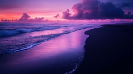 Obraz premium Purple Sunset Over Dark Sand Beach with Rolling Waves