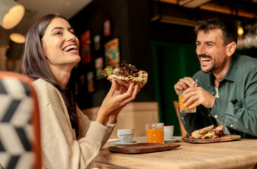 Enjoying a delightful brunch together at a cozy cafe on a sunny afternoon in the heart of the city