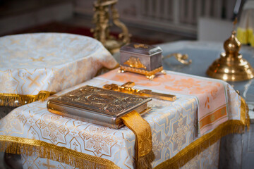 Orthodox ritual table with ornate gospel book and religious artifacts