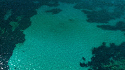 Aerial view of the surface of an emerald green sea. Ideal for background, texture and pattern.