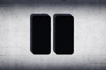 Two phones with a blank screen on a concrete background