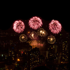 Fireworks over beautiful night city view in Vancouver, Canada.