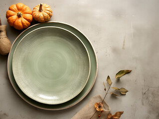 Flat lay composition of autumn harvest pottery and copy space. Rustic stoneware with fall decor. Sage plate on neutral background with pumpkins and herbs. Wabi sabi potteryn. Food blog concept