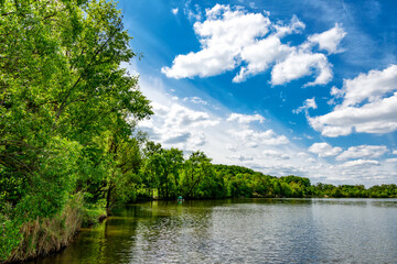 Carpfishing session at the Lake.Carp Angling scenic landscape overlooking lake at and blue sky with...