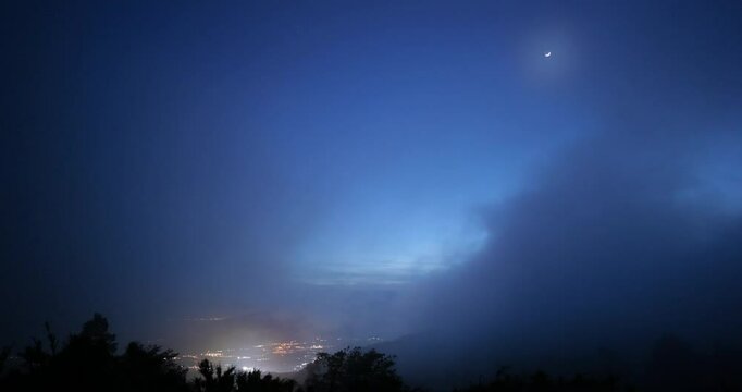 View of Gotemba city and the crescent moon from the foggy Hakone mountains in Japan. 4K,H.264,422,10bit.