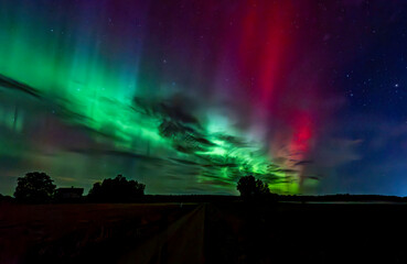 Northern lights dancing over country landscape in noreth of Sweden.