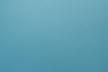 Simple minimalist blue textured background with a smooth surface, perfect for design projects.
